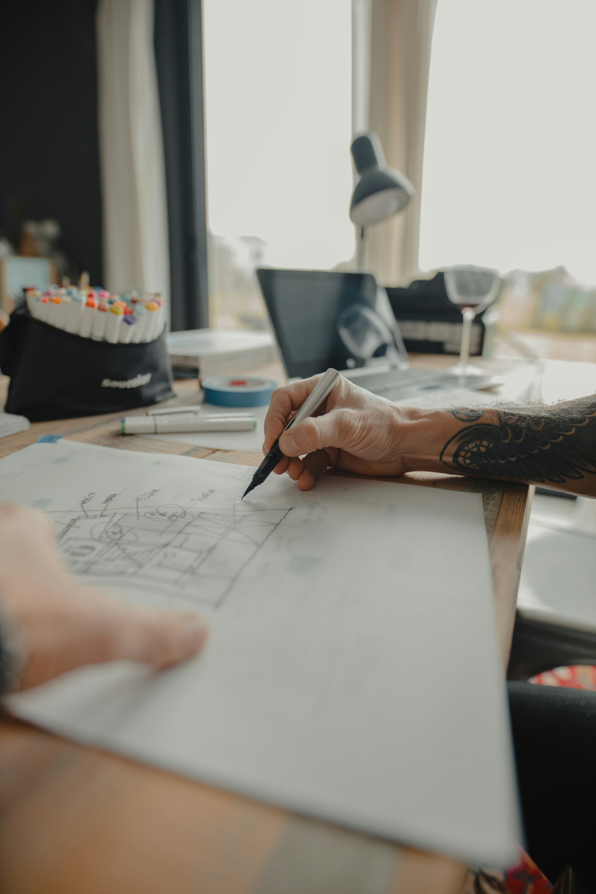 Designer sketching wireframes at a desk